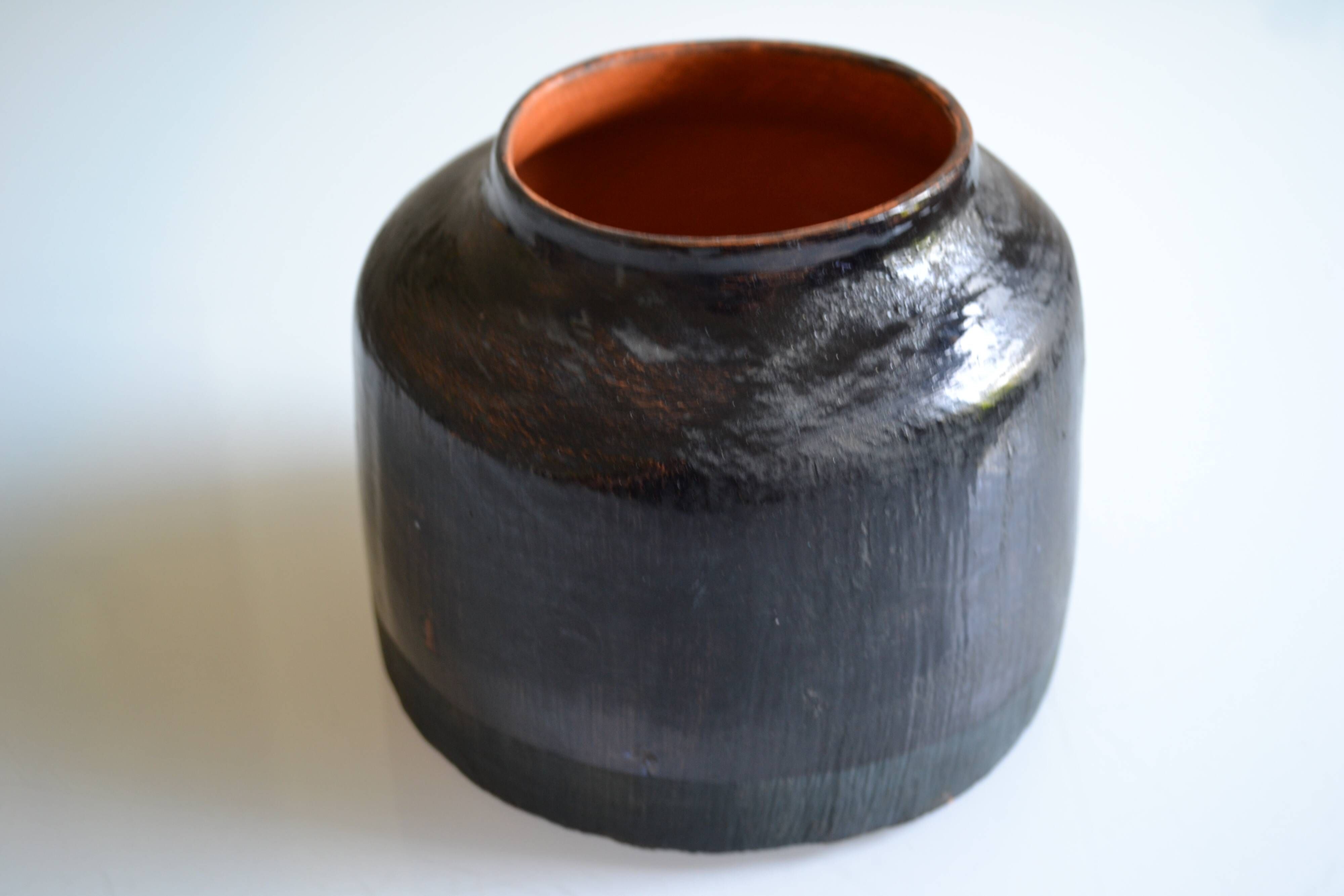 Ceramic vase with a signature fish to identify.
