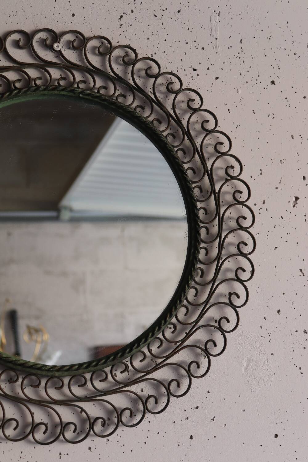 Large round vintage mirror in black metal with green patina