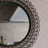 Large round vintage mirror in black metal with green patina