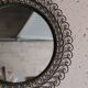 Large round vintage mirror in black metal with green patina