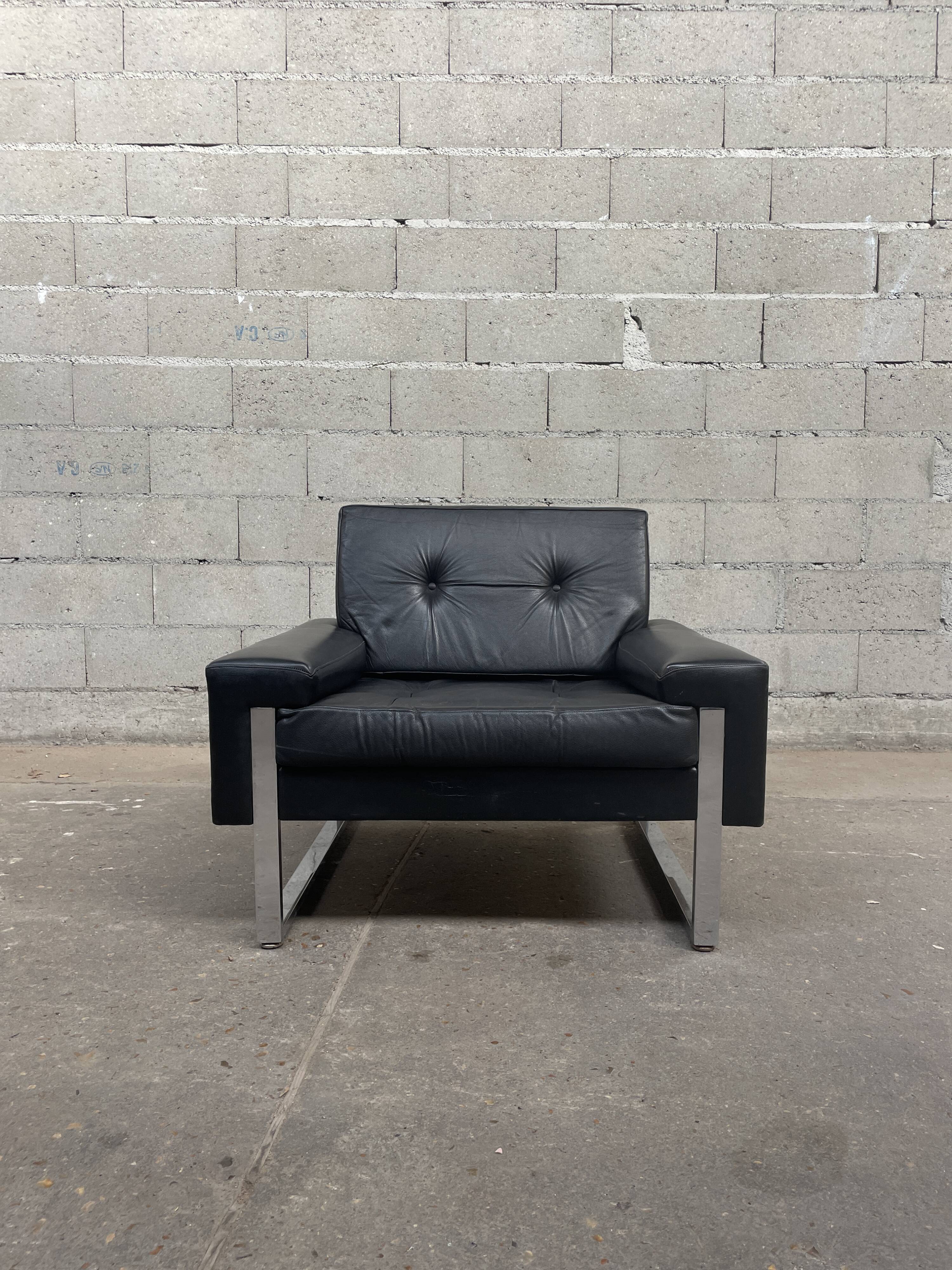 Pair of black leather armchairs