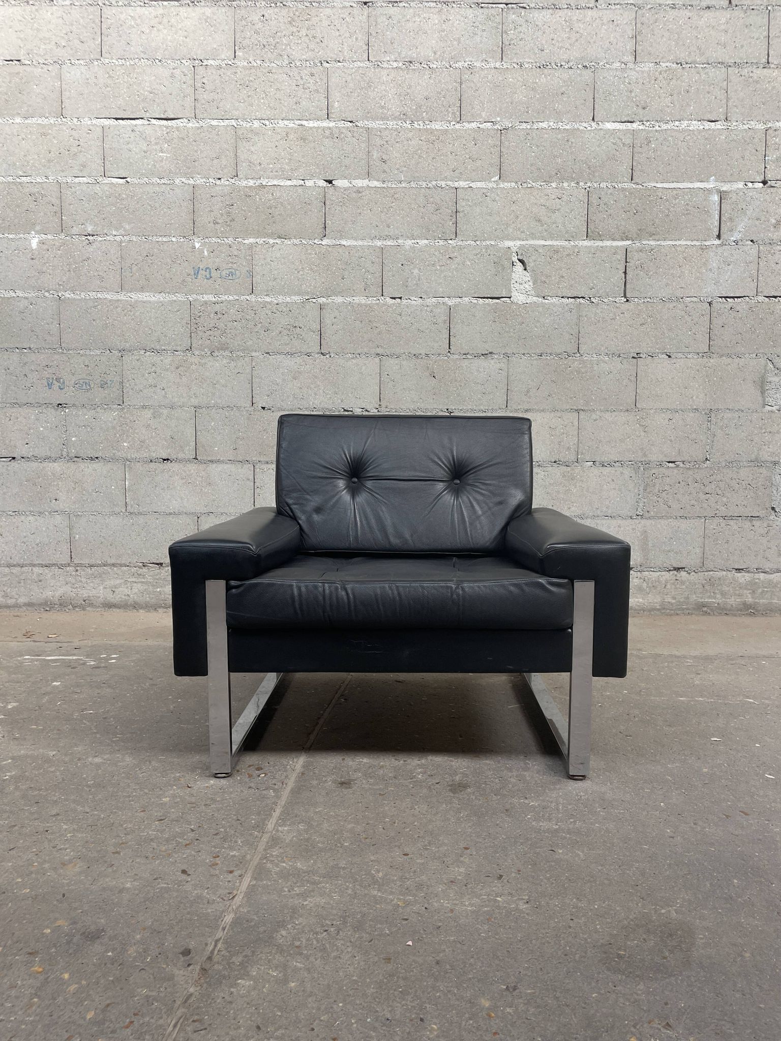 Pair of black leather armchairs