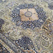 Large Persian wool rug 250x350 cm in gold and navy blue.