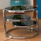 Coffee table with pivoting metal and black glass elements.