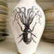 White and gold porcelain vase with black patterns by Mauricio Ortiz