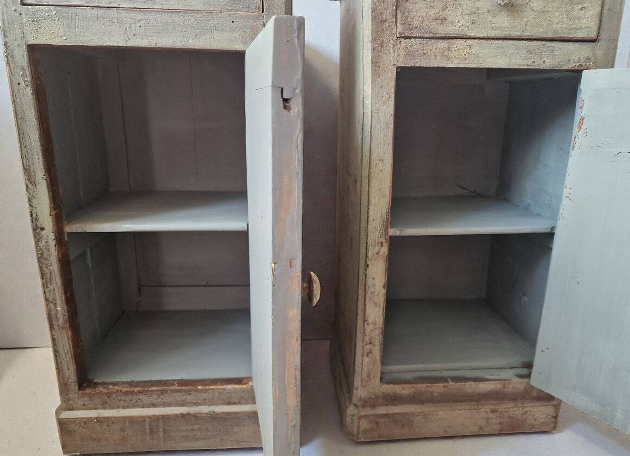 Pair of antique bedside tables with a green patina