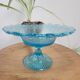 Plate on blue glass pedestal