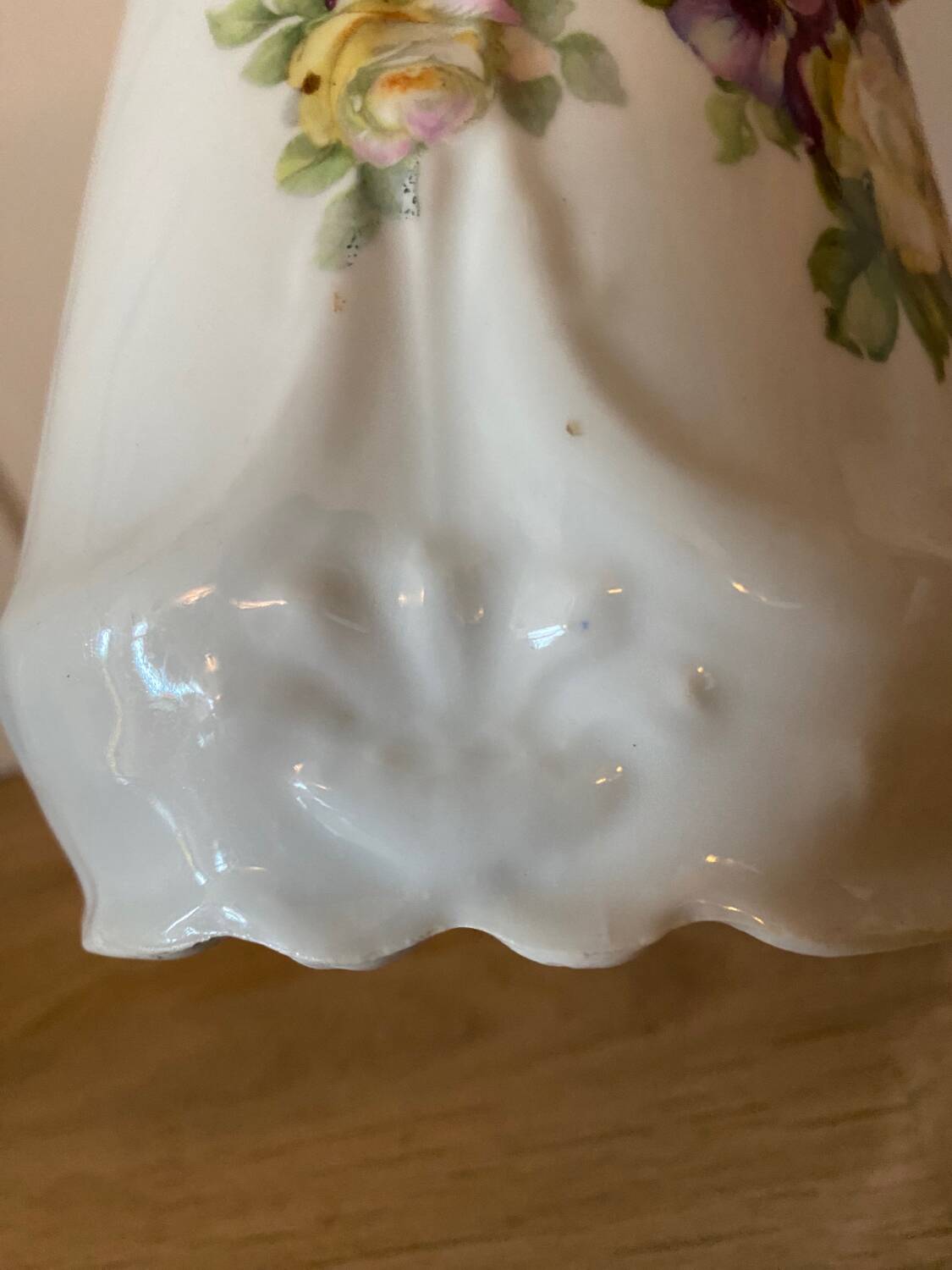 Old ceramic pitcher decorated with flowers