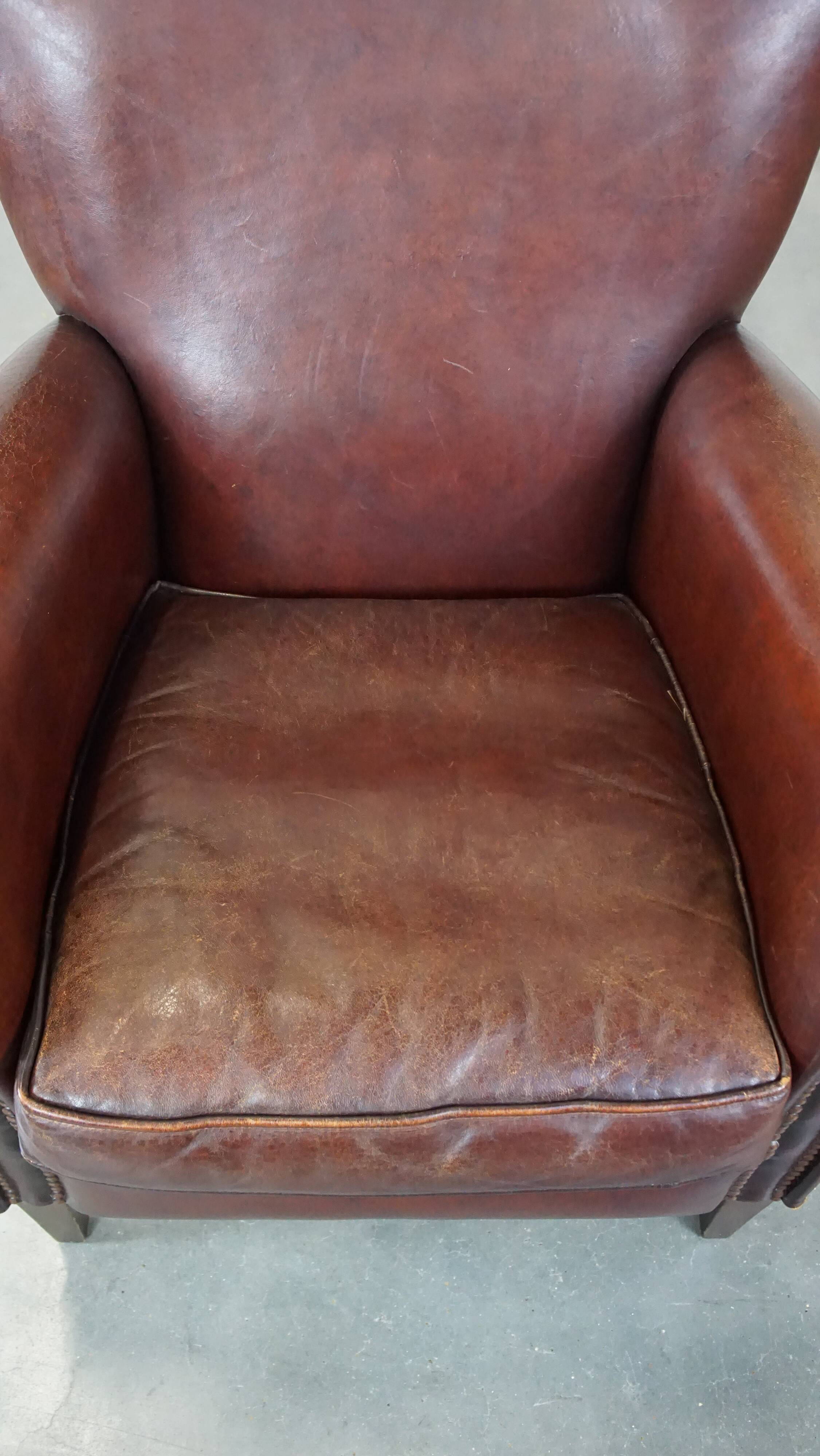 Sheep leather armchair correctly finished with decorative nails