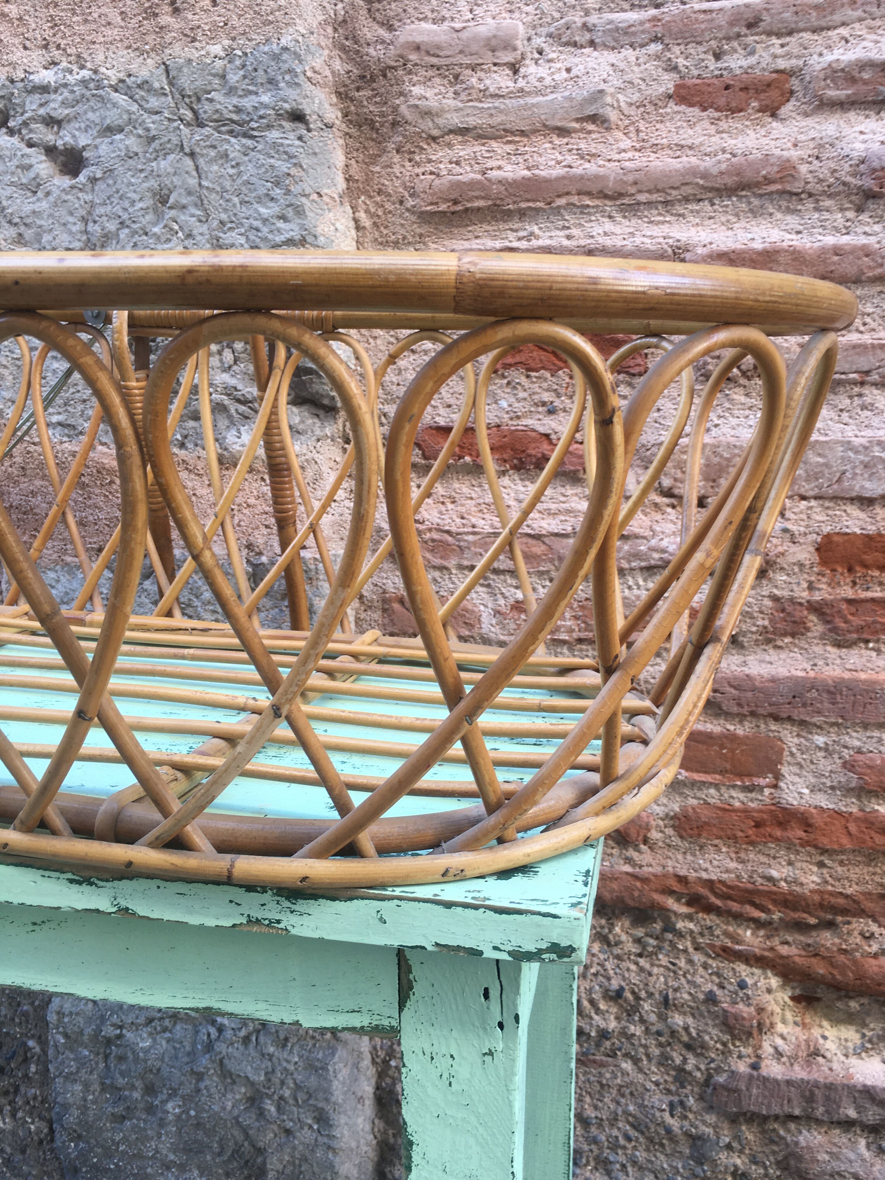 Rattan bassinet with hood arches