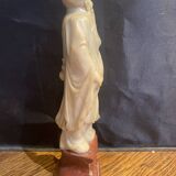 Soapstone sculpture on obsidian base of a Buddhist.