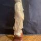 Soapstone sculpture on obsidian base of a Buddhist.
