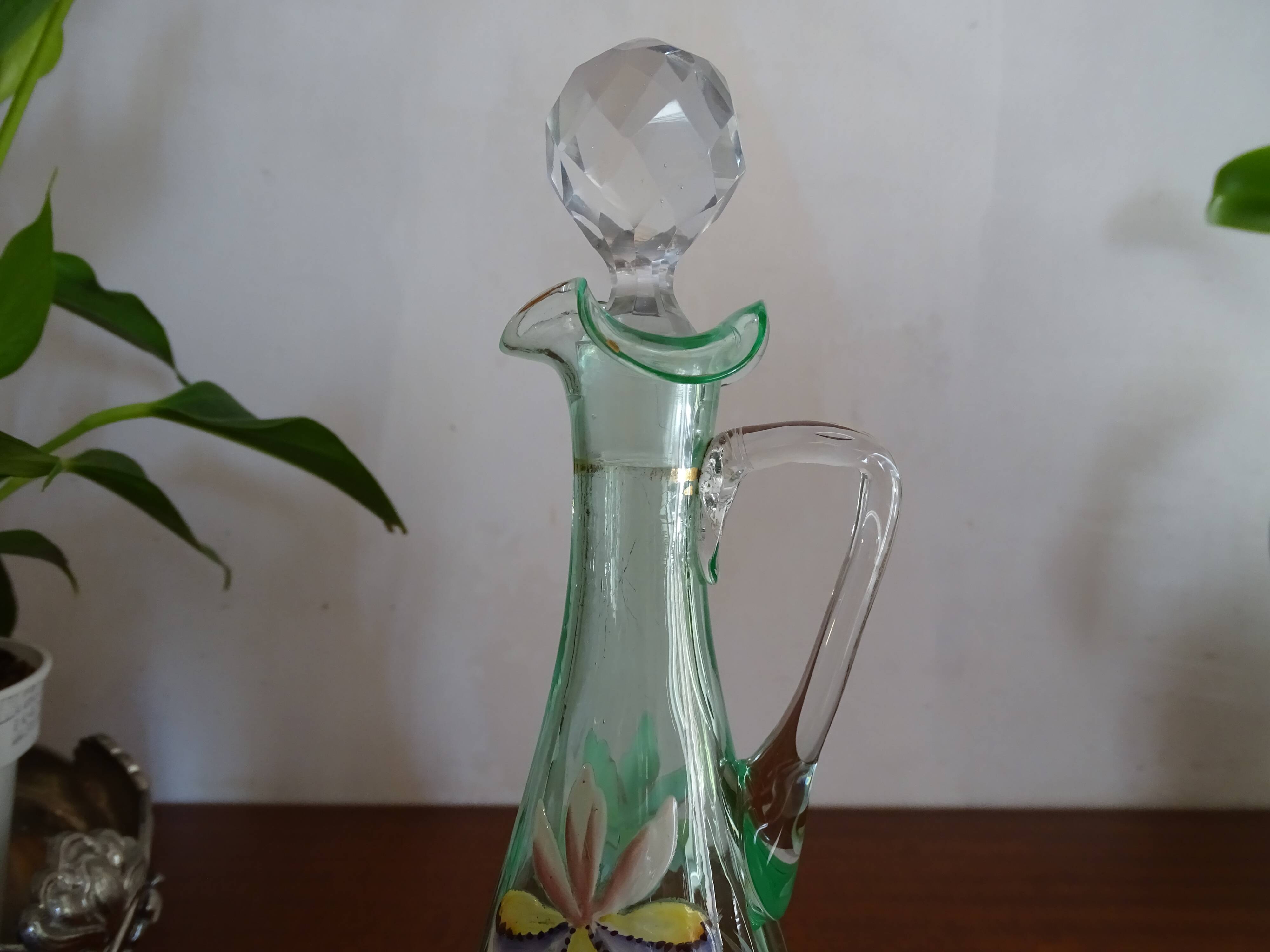 Old carafe enamelled with glass flowers