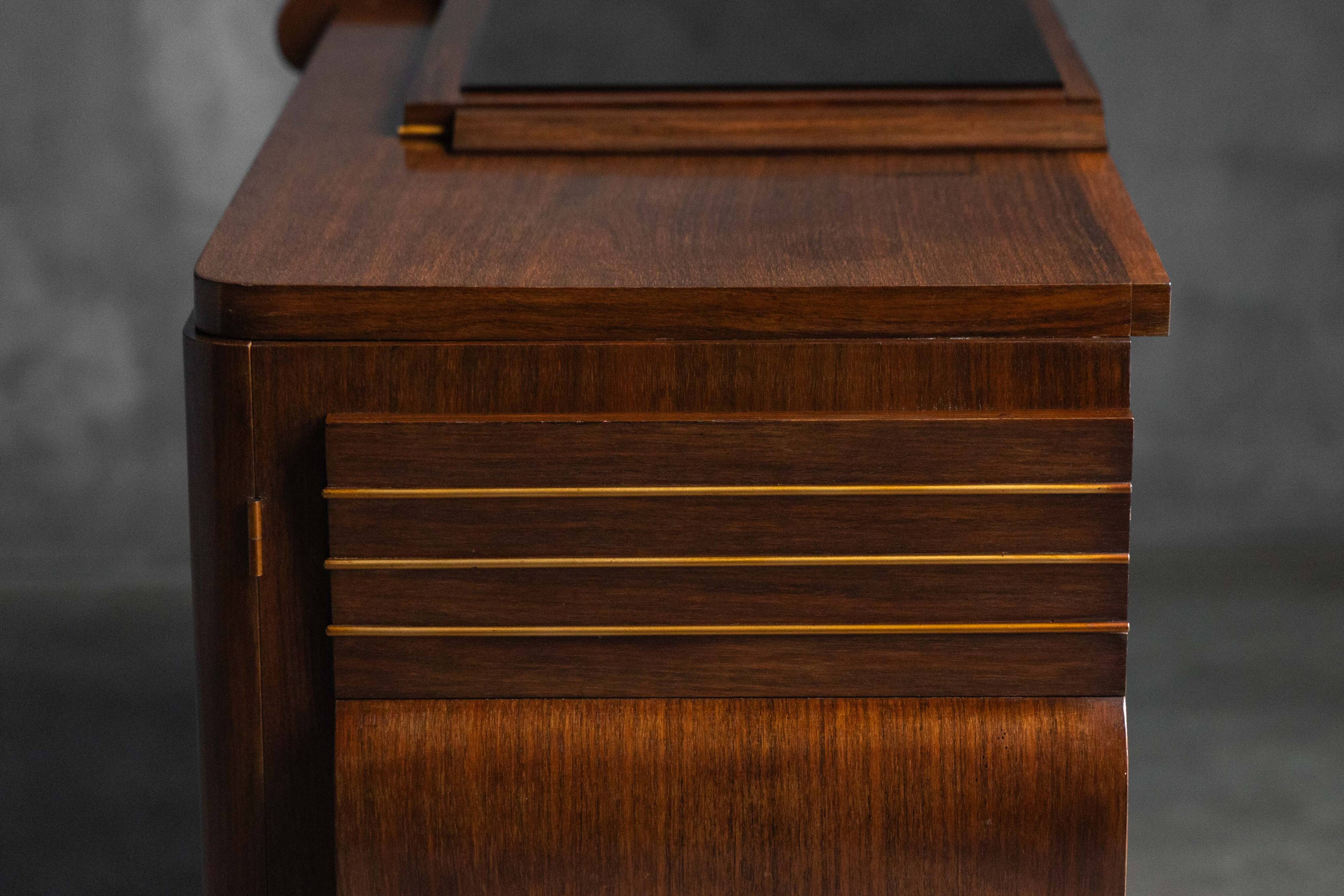 Art Deco walnut sideboard with brass details and sculptural base, France, 1930s