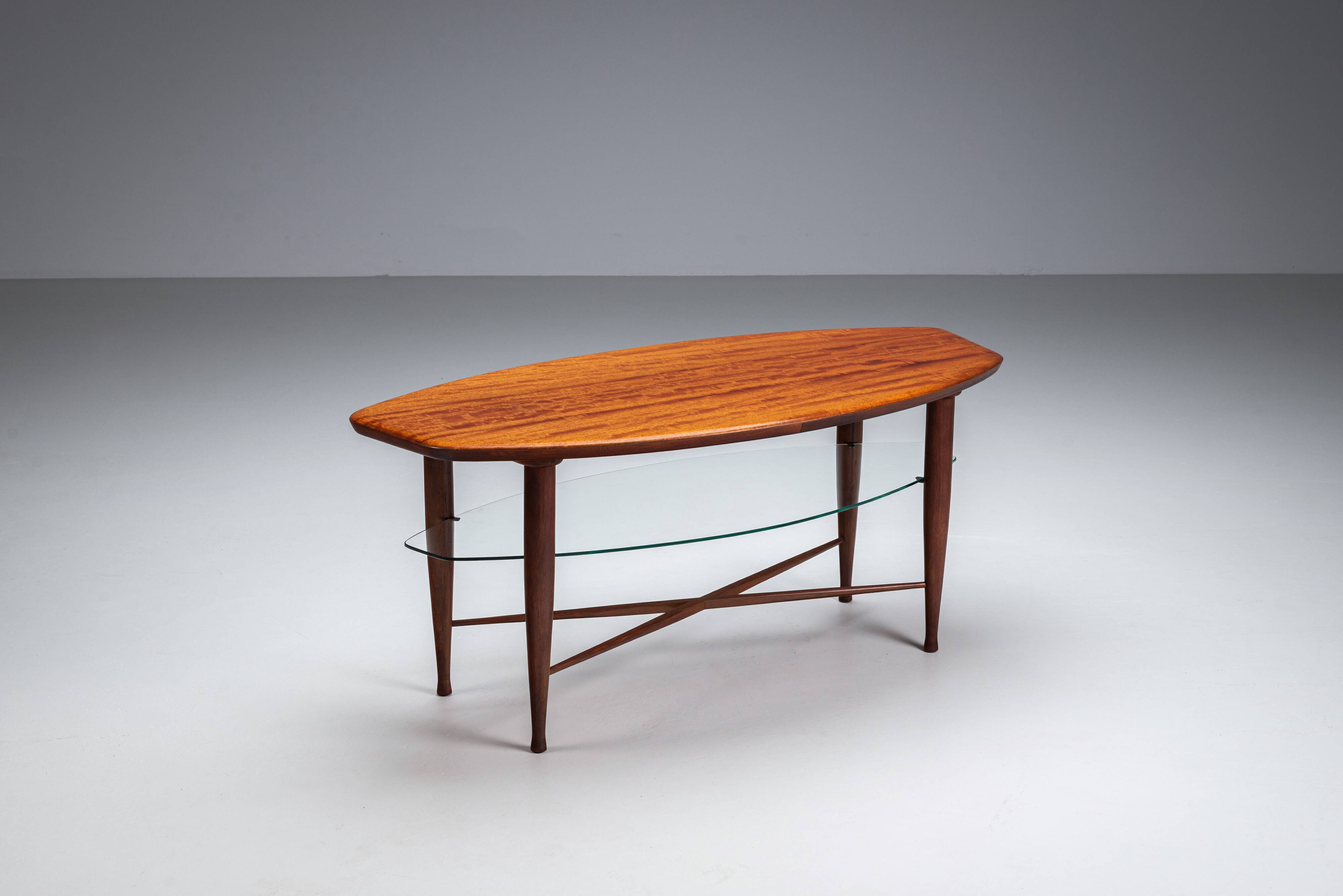 Assymetrical coffeetable with glass storage and cross leg details