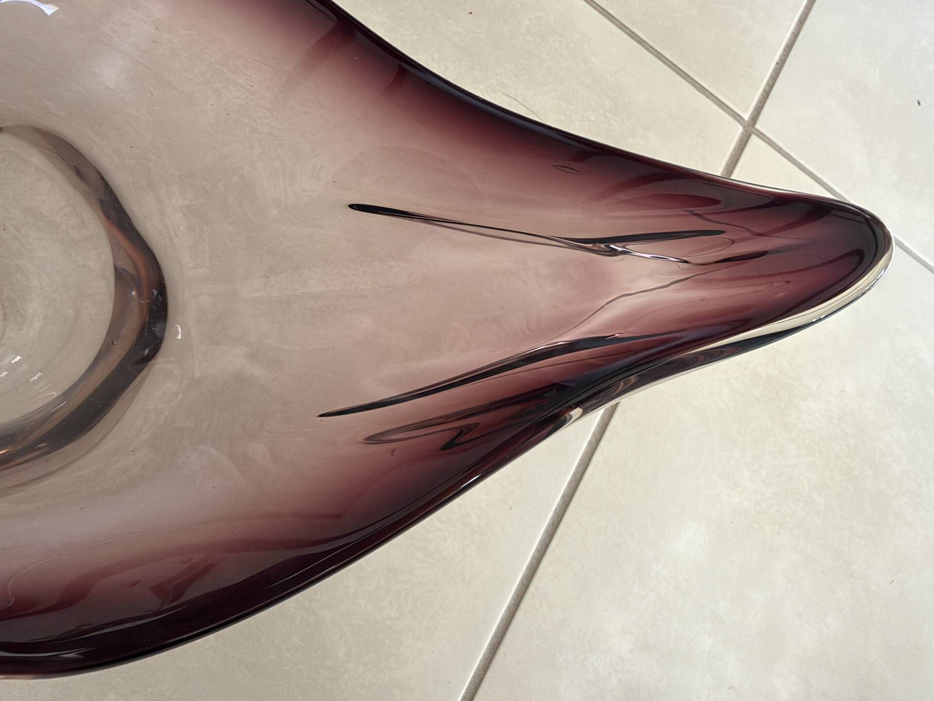Blown glass fruit bowl in Murano style with purple reflections.