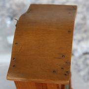 Vintage wooden shelf with drawers and mesh door.
