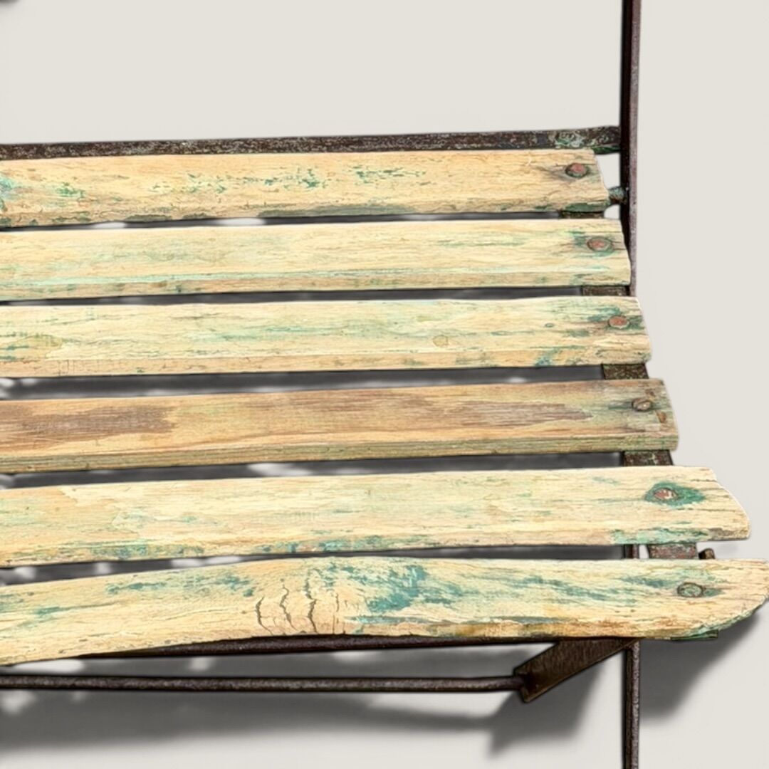 Bistro tables and folding chairs with a patina from the original 1930s.