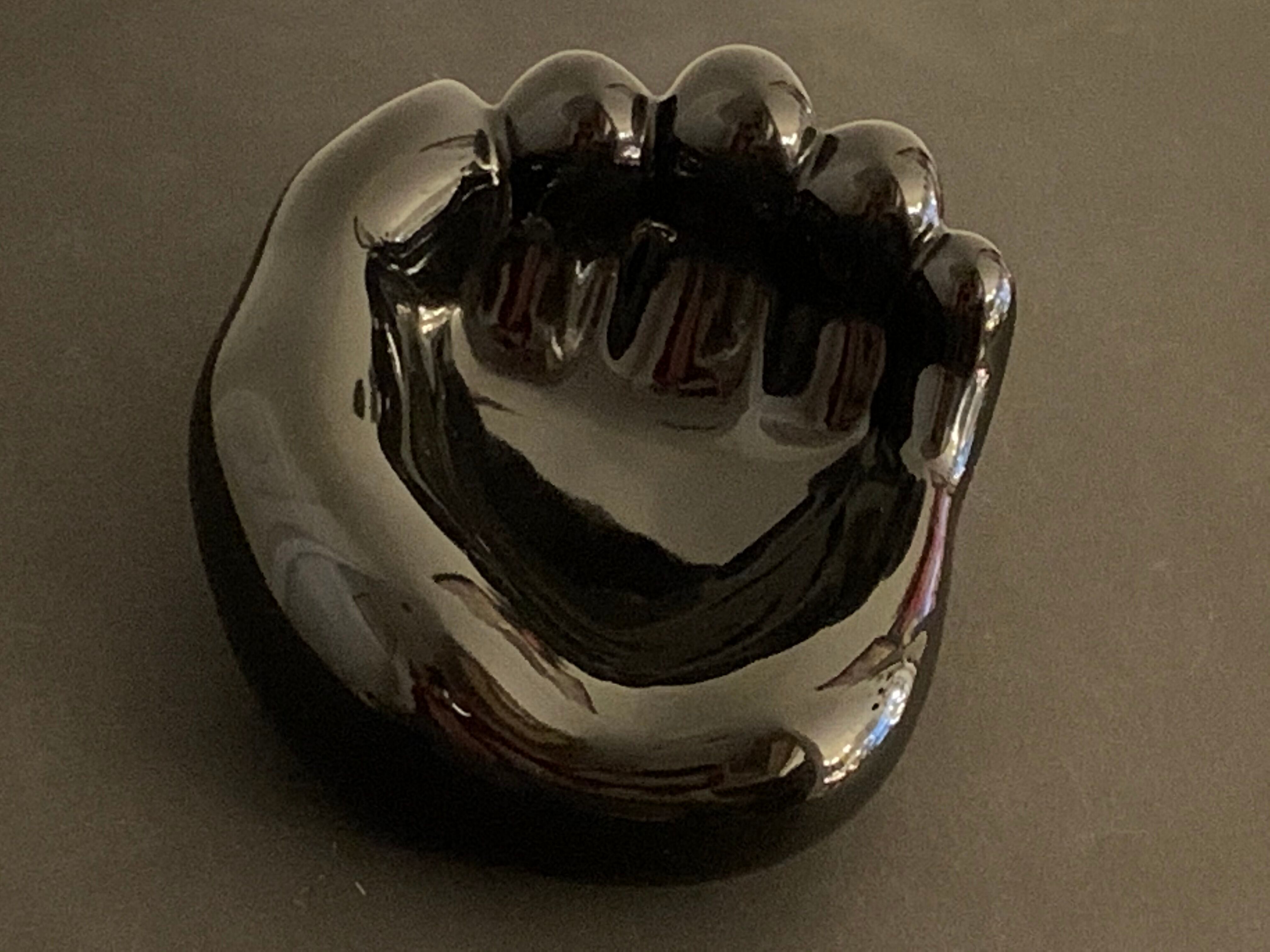 Black ceramic ashtray left hand