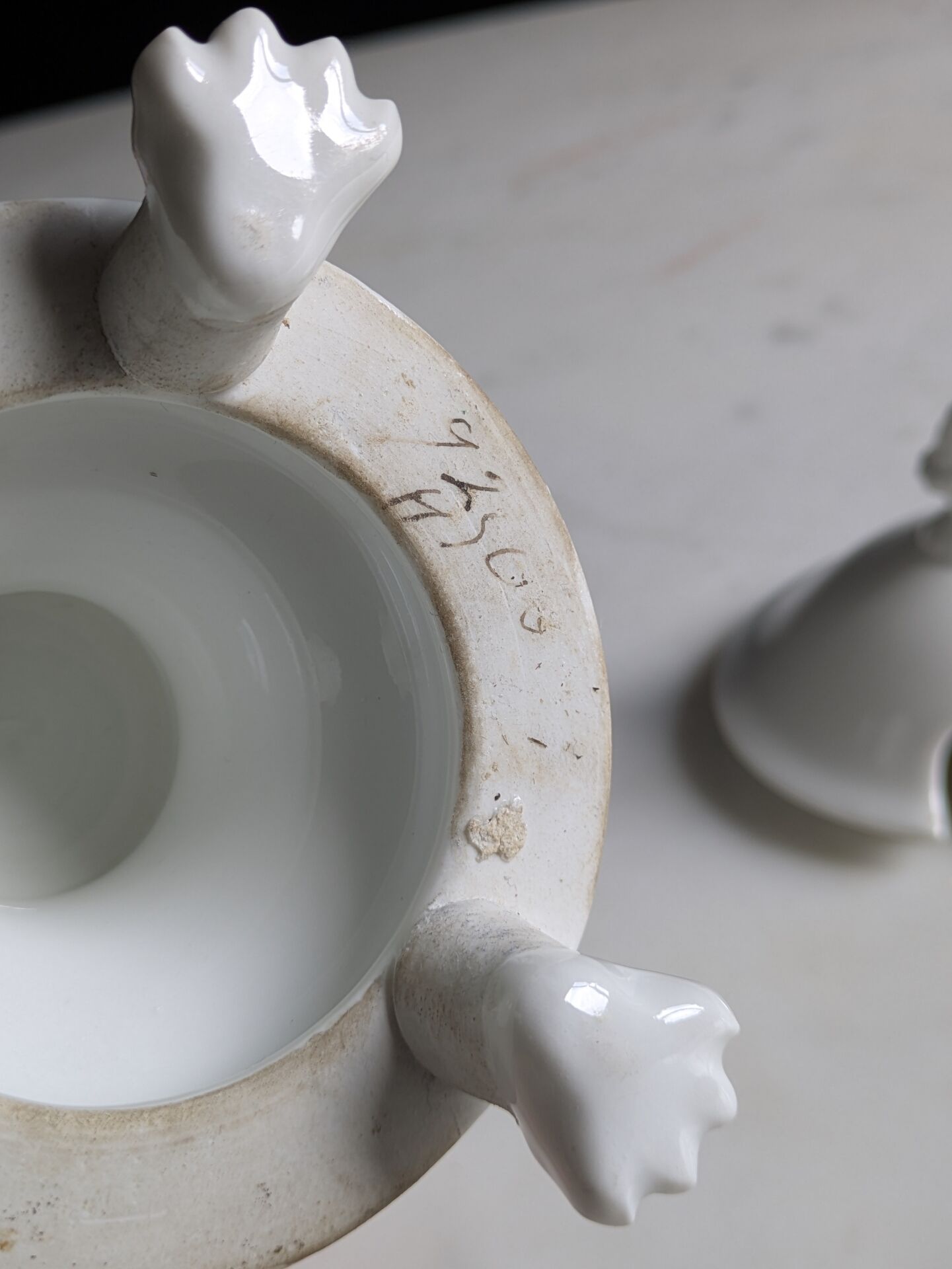 White porcelain confiturier with lion paws and masks. 19th century.