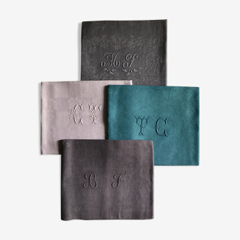 Set of four old damasked and monogrammed towels, tinted multiple colors
