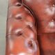 Cowhide chesterfield armchair in a warm brown colour with decorative nails