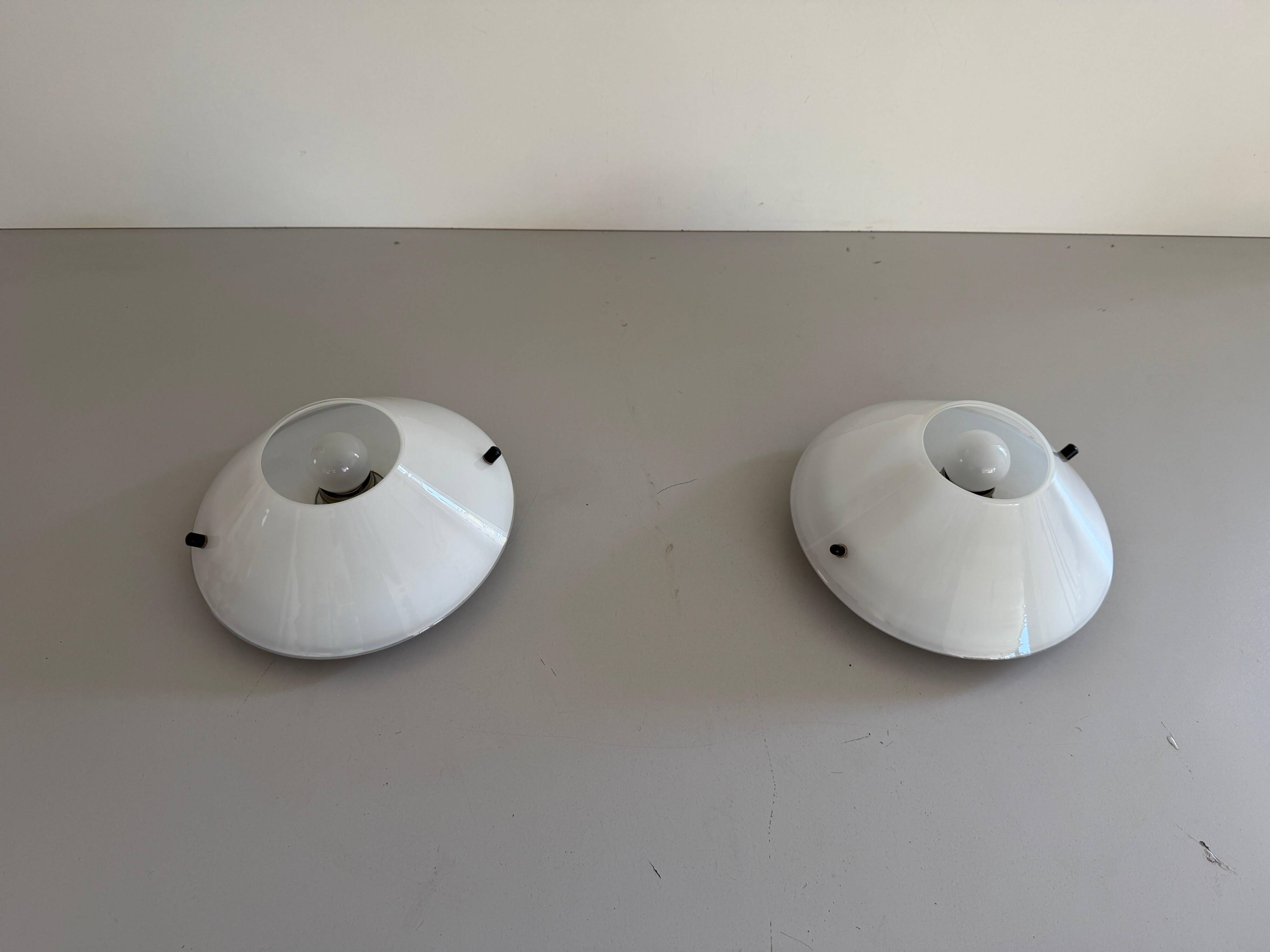 Pair of opal glass wall lights from the mid-century by Lamperti, 1960s, Italy.
