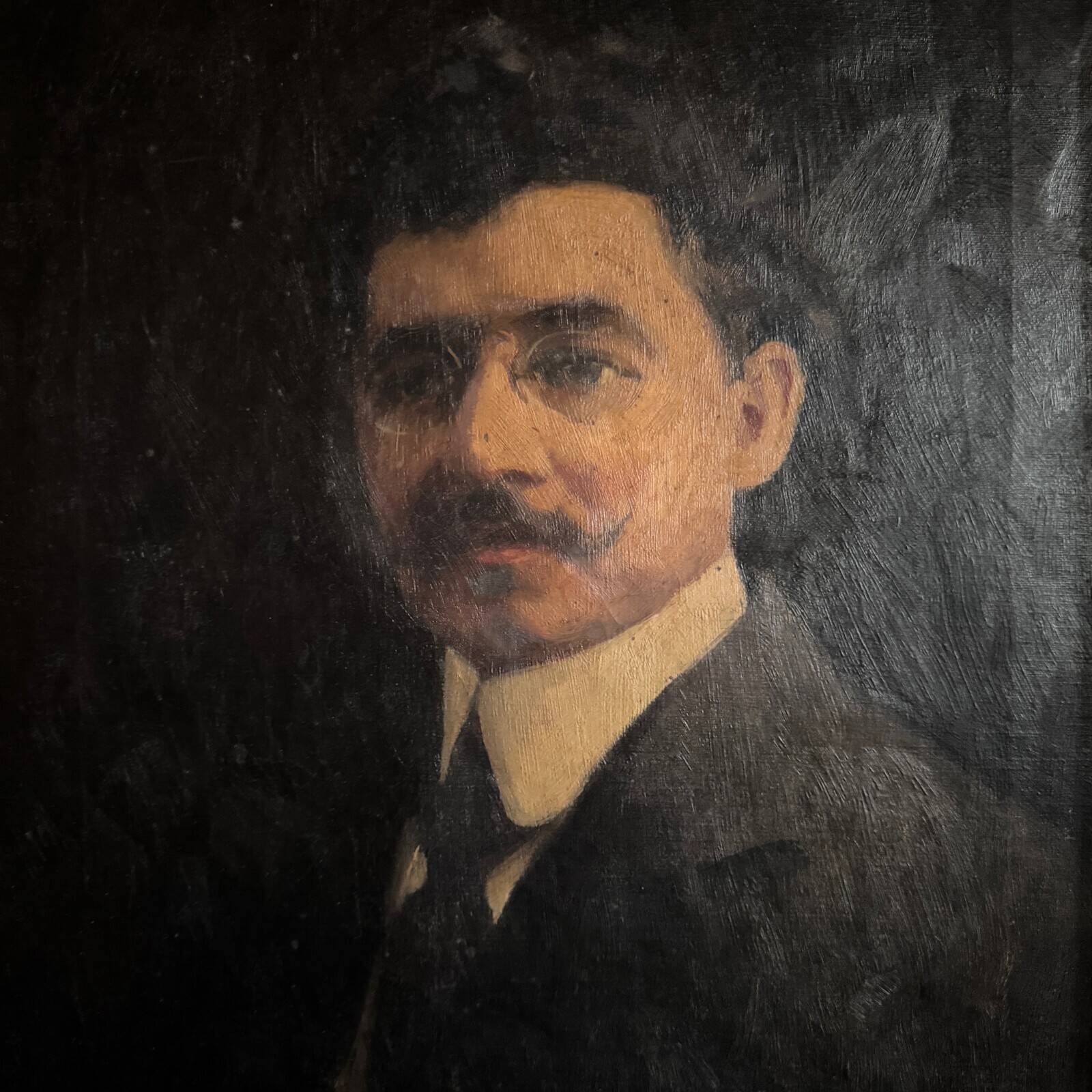 Oil on canvas portrait of a man wearing glasses and a mustache, early 20th century