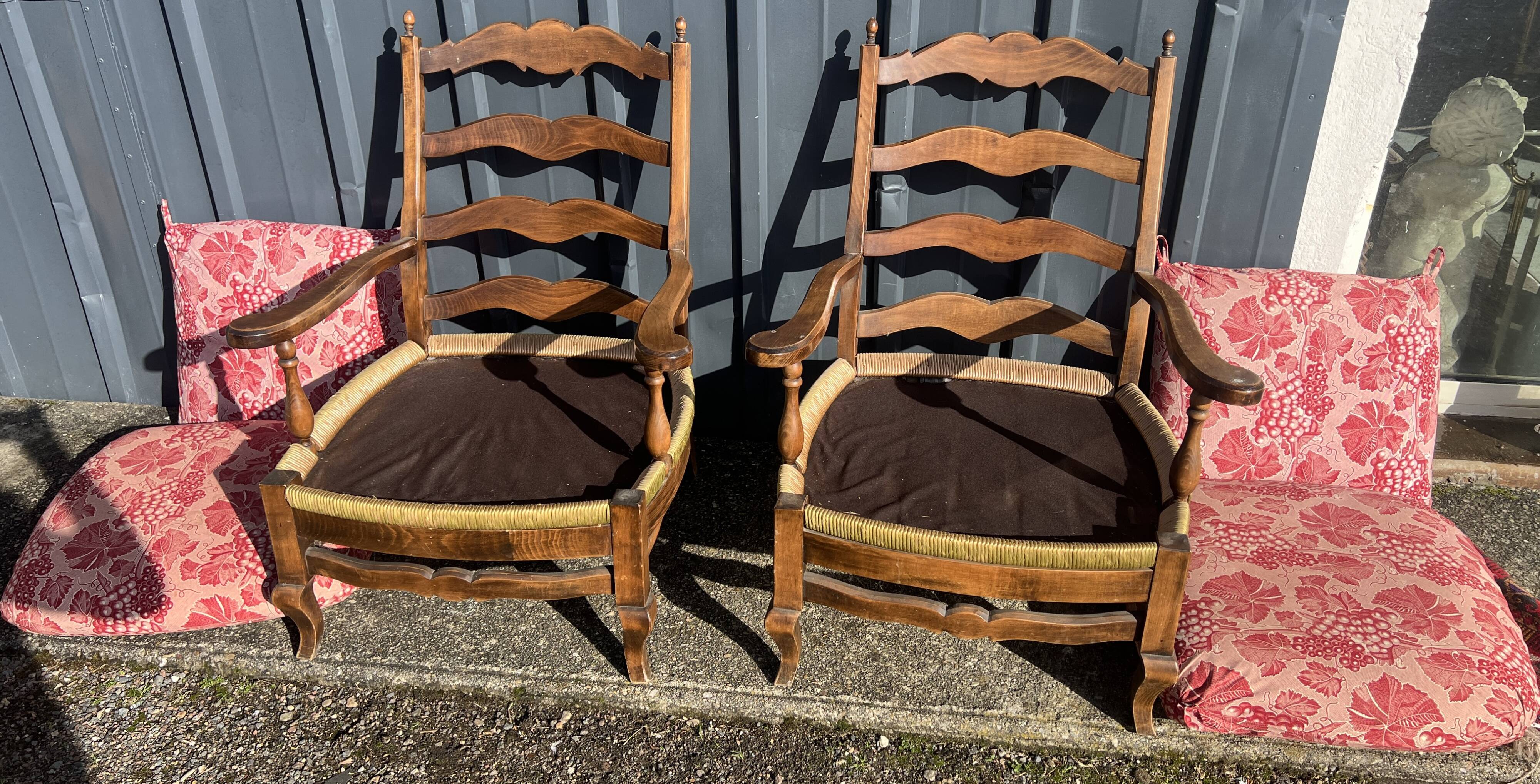 pair of rustic wood and fabric armchairs