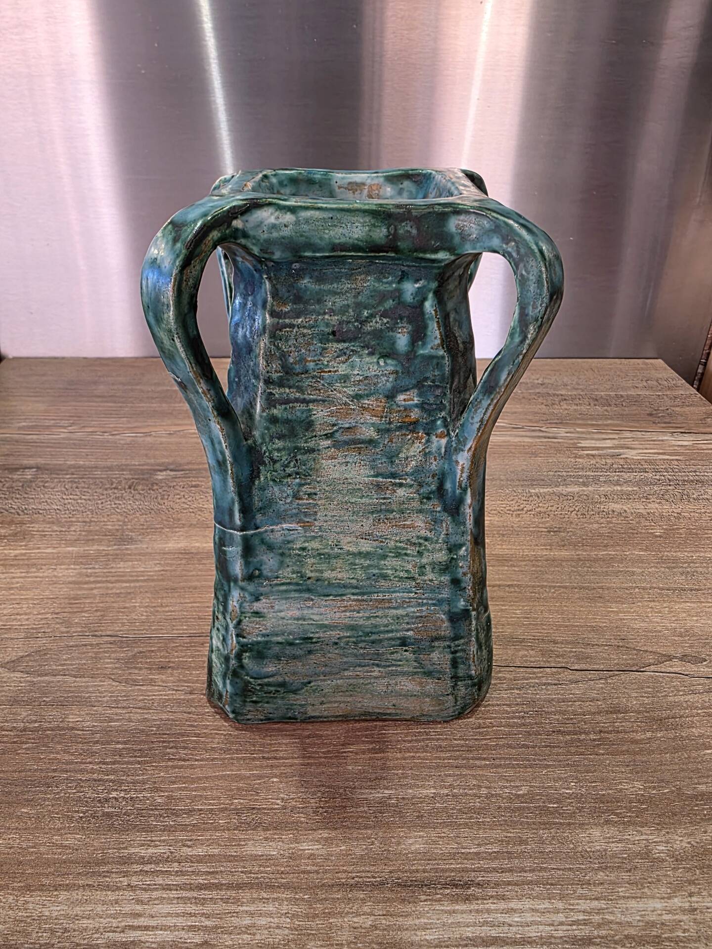 Vintage brutalist ceramic vase with 4 green handles.
