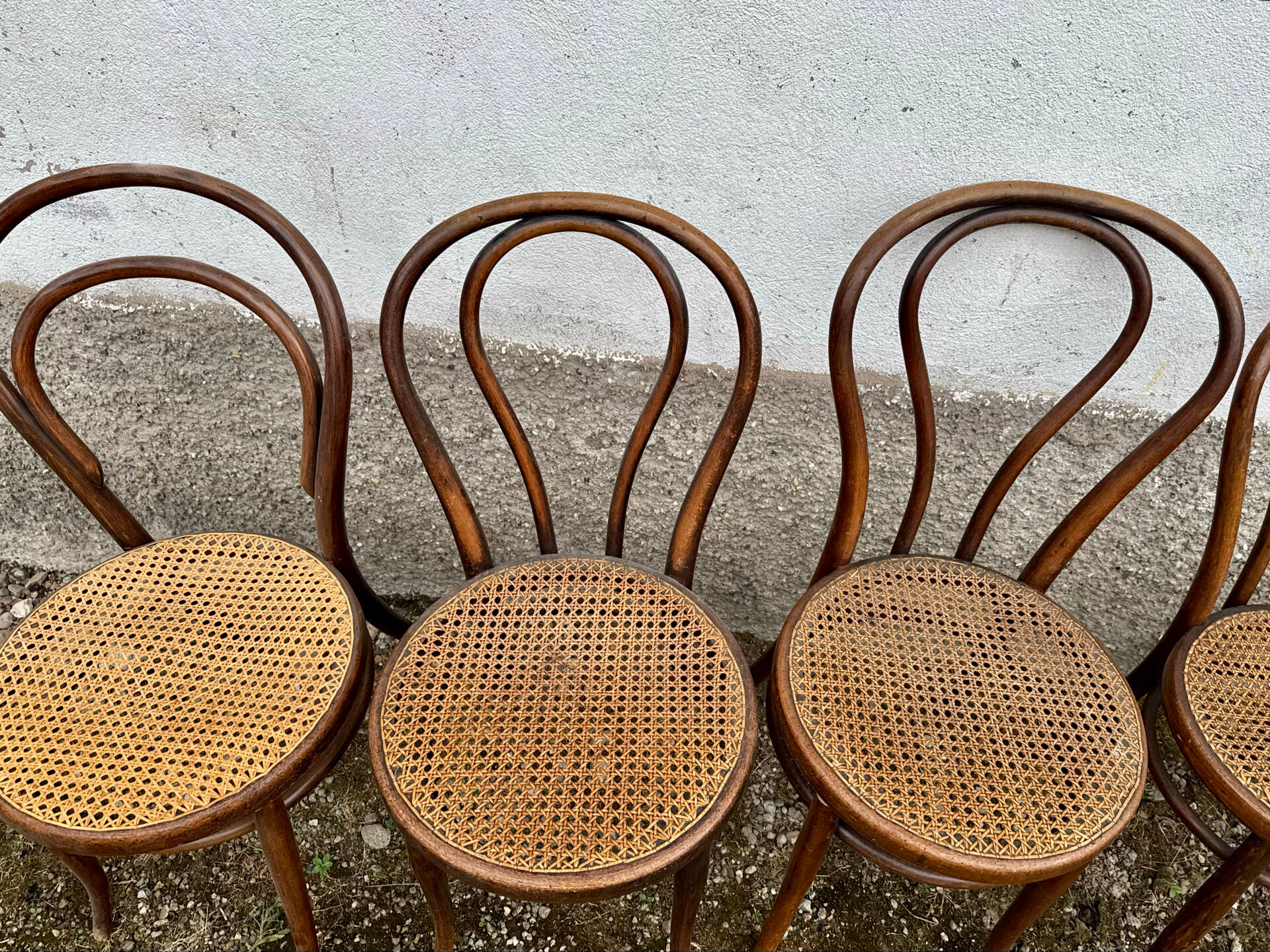 Set of 10 bentwood bistro chairs with cane seat.