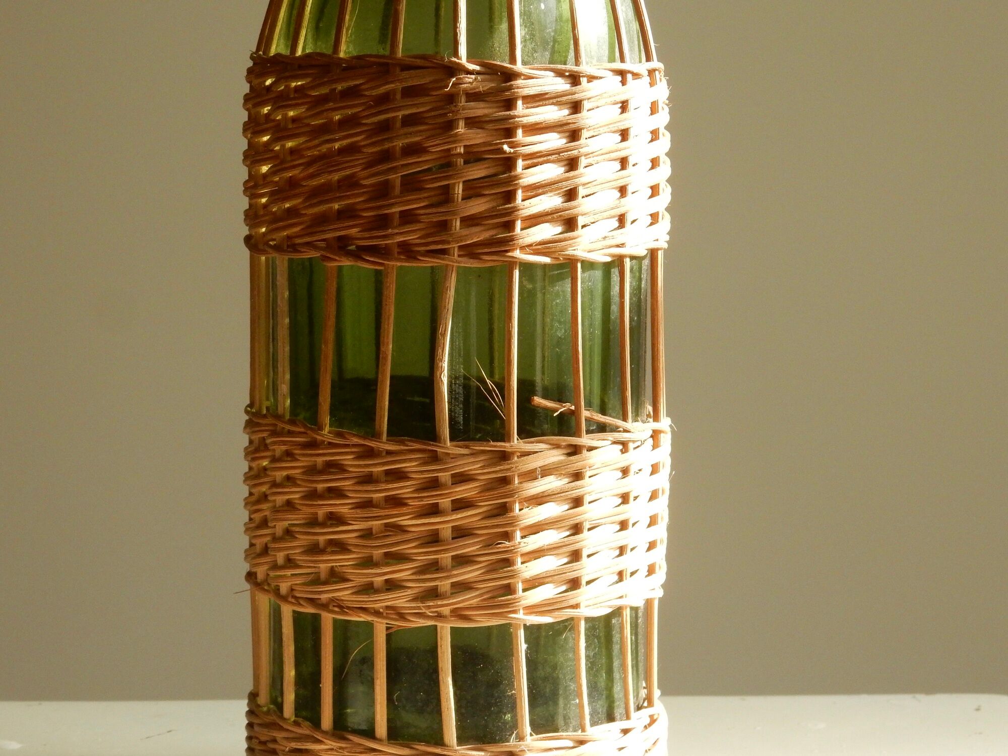 Glass bottle covered with wicker, France of the 60
