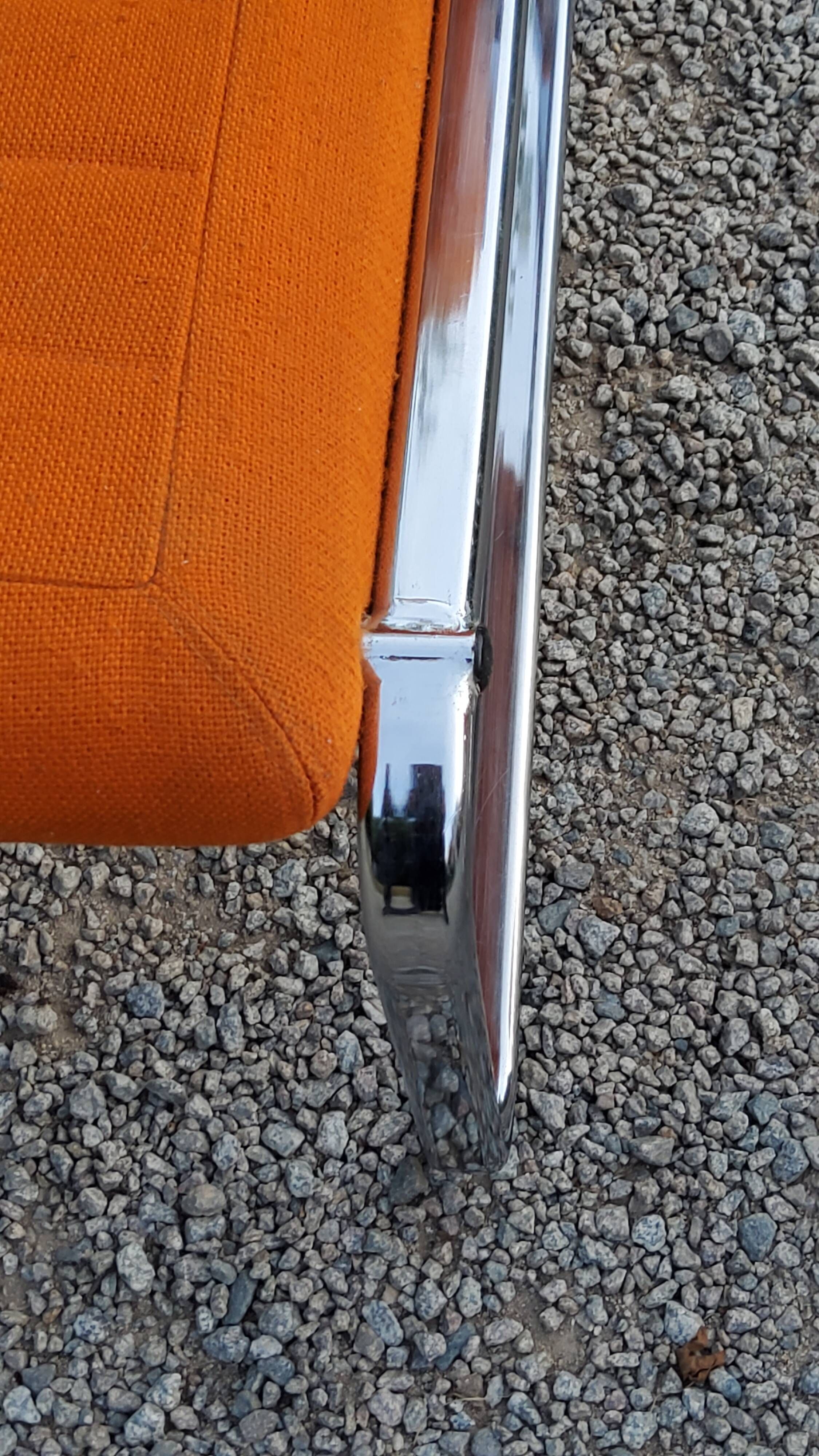 Pair of designer armchairs in orange fabrics and chrome tubes from the 70s