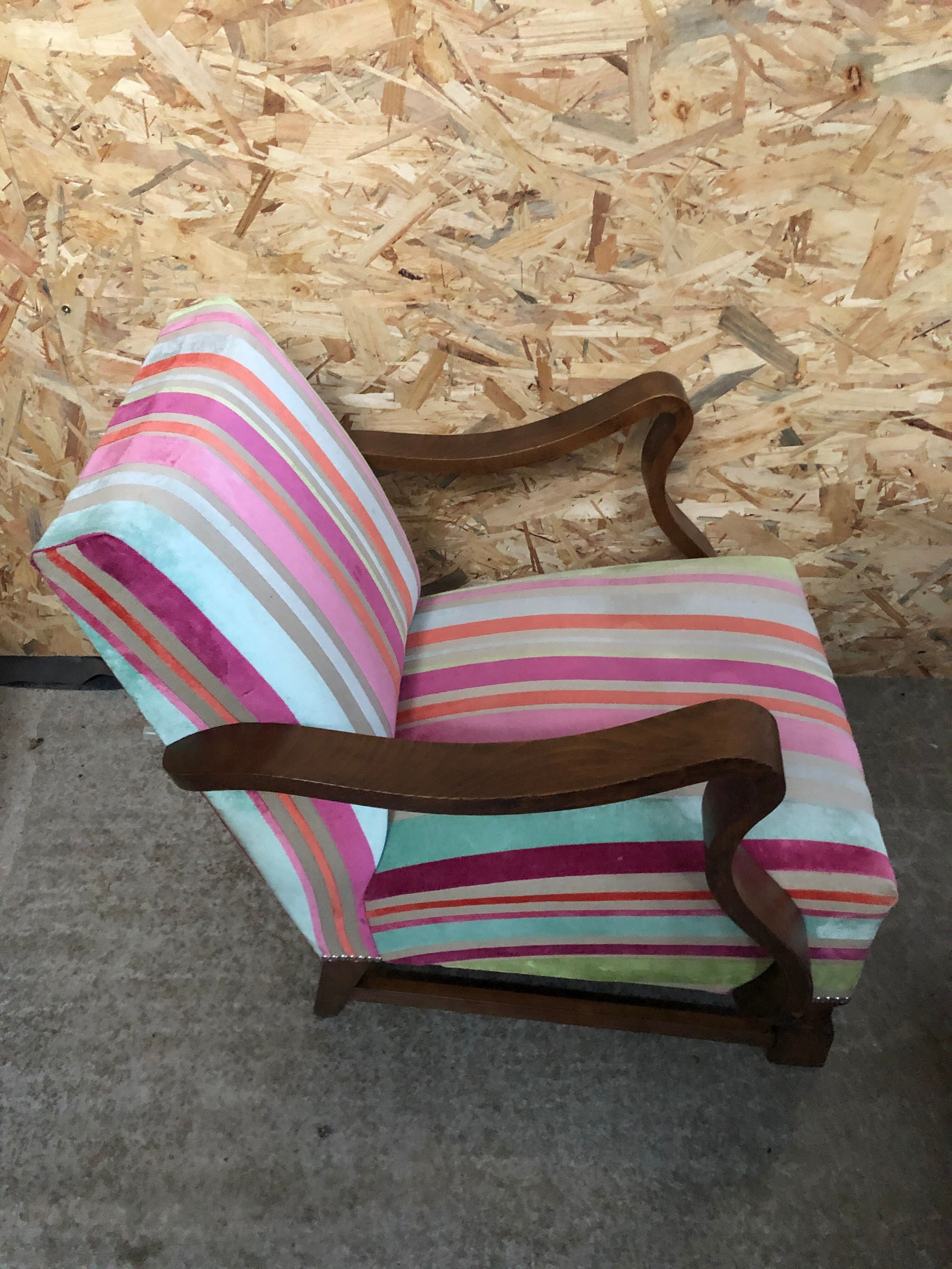 Old wooden armchair with curved armrests