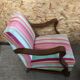 Old wooden armchair with curved armrests