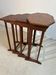 Four nesting tables with polygonal tops and decorative inlays.