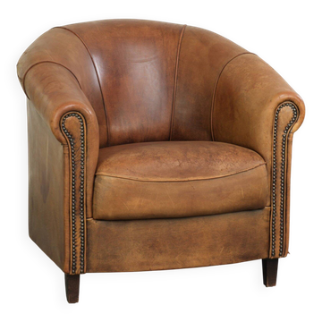 Aged sheepskin clubchair with beautiful vintage patina and comfortable seat