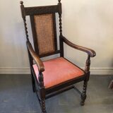 Carved wooden armchair and cannage
