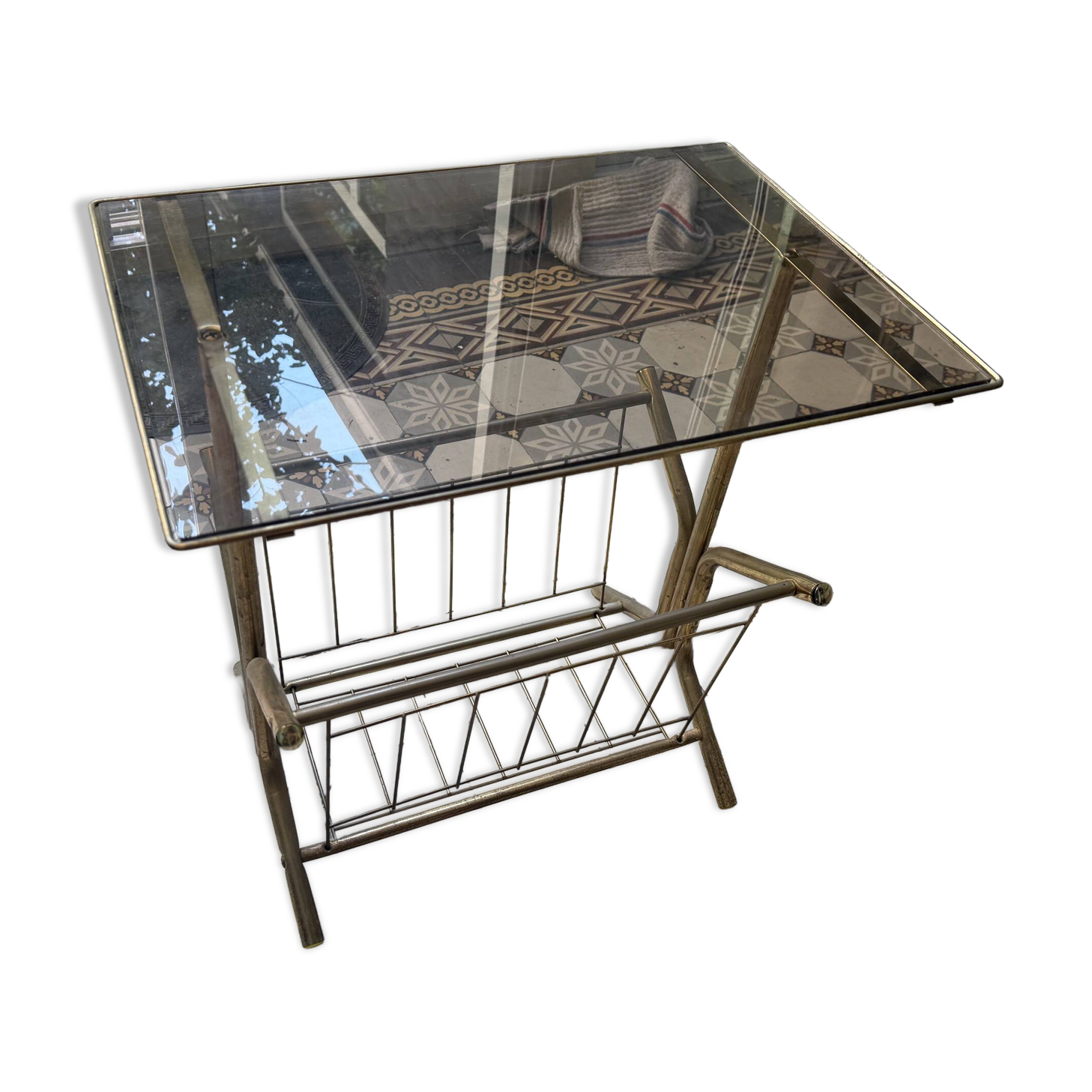 Vintage style side table with magazine holder, gold metal and glass top.