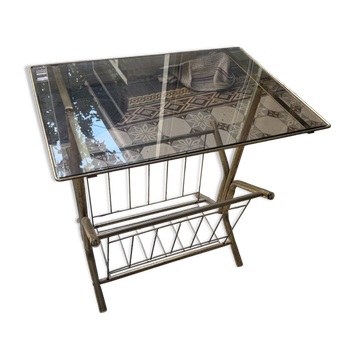 Vintage style side table with magazine holder, gold metal and glass top.