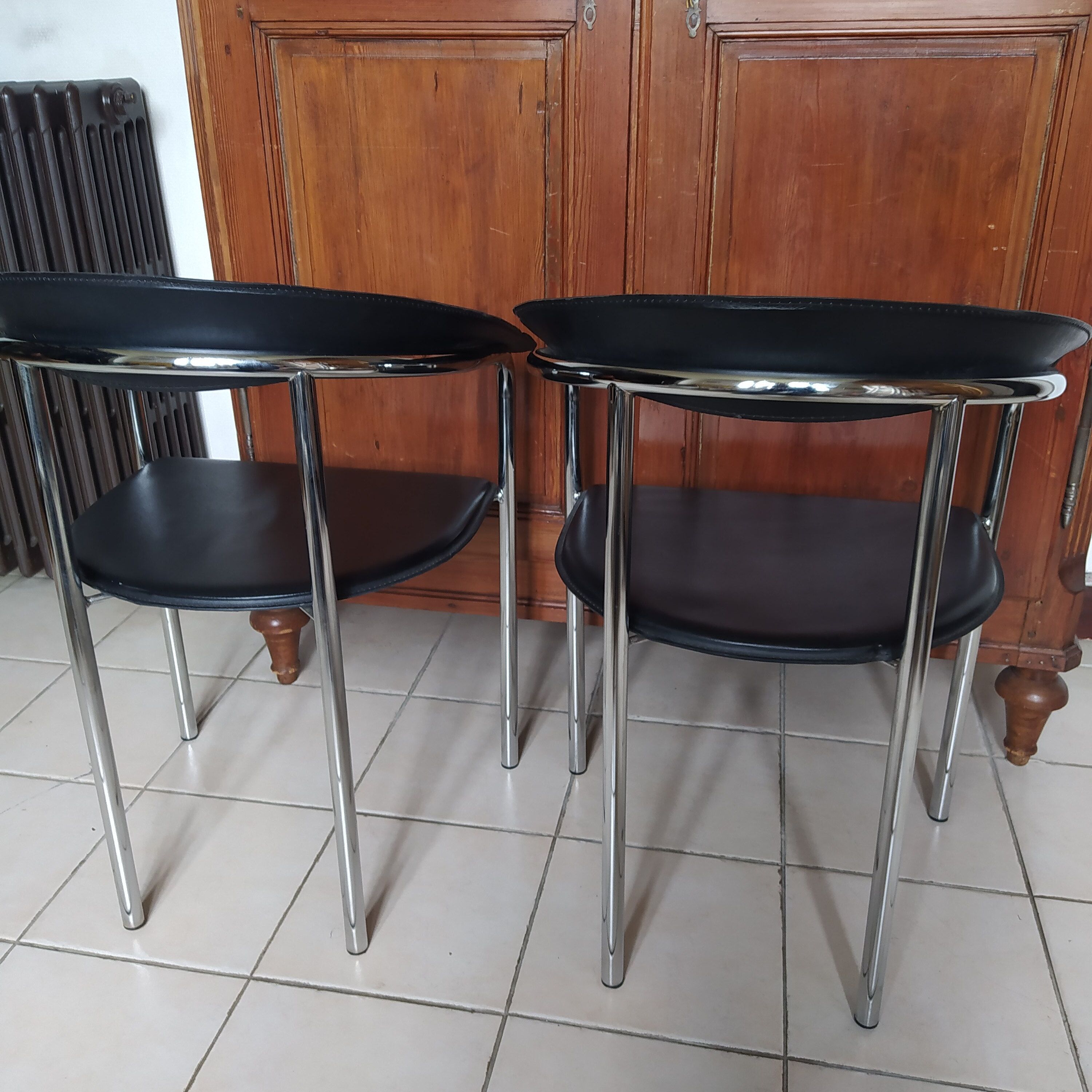 Pair of black and chrome leather Italian armchairs