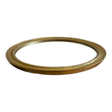 Round mirror with golden wood frame