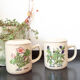 2 tea cups in enamelled speckled sandstone flower décor