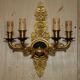 Pair of L'Originale wall sconces plated with 24-carat gold featuring four bronze candles.