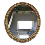 Large oval mirror in wood gilded with fine gold