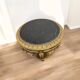 A round Louis XV style table in carved gilt beechwood with a black marble top