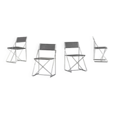 Four stackable Nuova X-Line chairs by Niels Jorgen Haugesen for Magis.