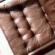 Scandinavian armchair with turned wood and brown patchwork leather, 70s design.