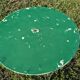 Antique round folding garden table with a green patina.