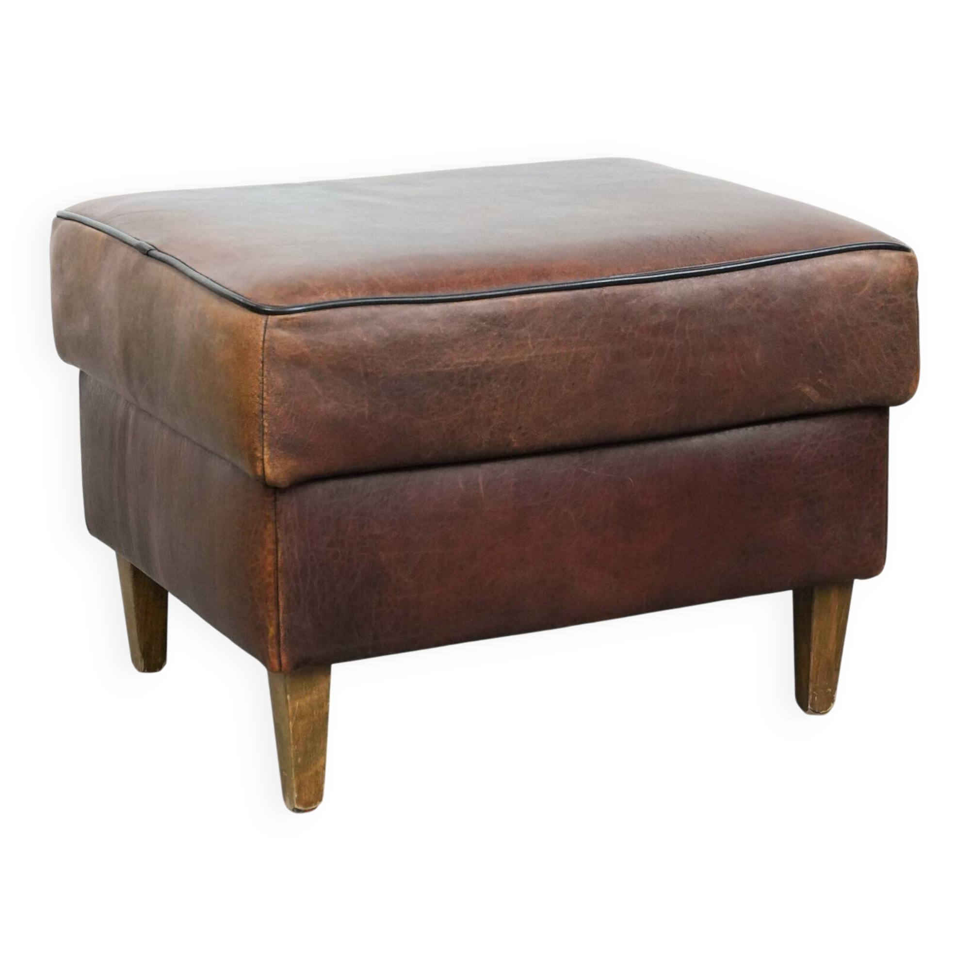 Sturdy vintage sheepskin ottoman in a beautiful large size with black piping